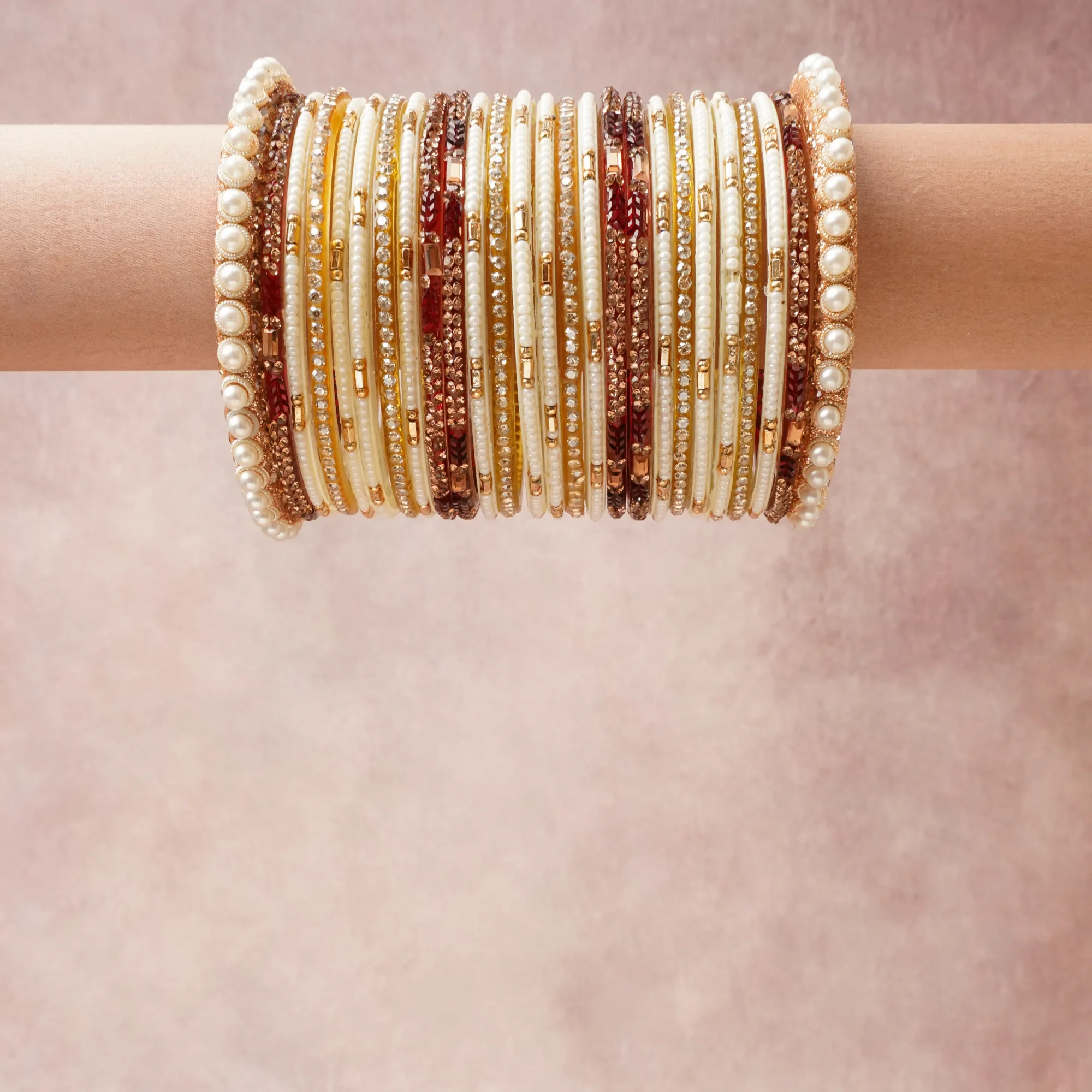 A grounding Ivory forms the heart of the set, while touches of Gold, Burgundy, Clear Crystal add charm.

A thoughtful composition of Pearls, Glass Beads, Gold-toned Metal, Crystals, designed to feel complete without being heavy.
Each element layers seamlessly, creating a look that is refined, wearable and quietly striking.